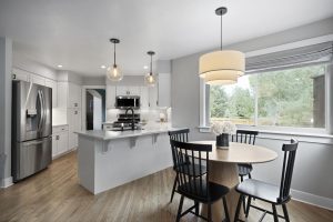 Updated kitchen with white cabinetry and stainless steel appliances at 8060 W 78th Circle